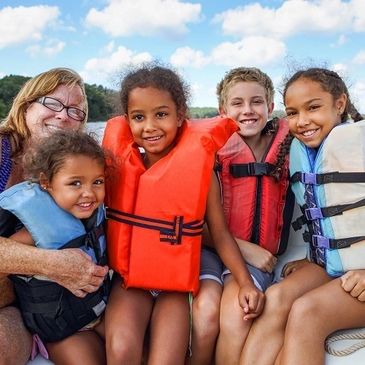 Family on boat wearing life jackets