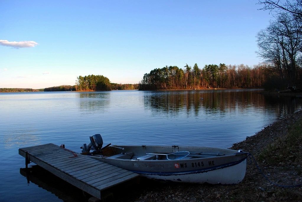 Calm lake with dock at morning light