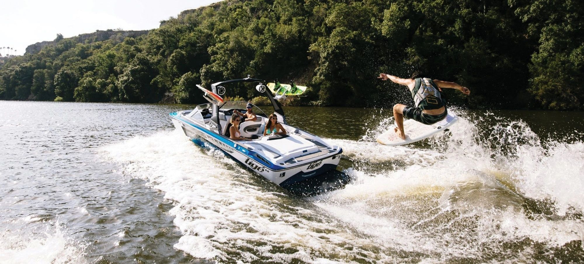 Wakeboard boat creating enhanced wake on lake
